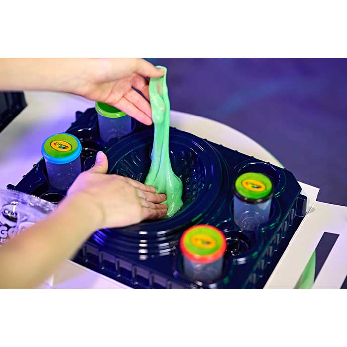 Galactic Goo All-In-1 Sensory Station. Hands making galactic goo in base station.